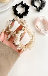 Detail of sheer organza scrunchies with translucent beads and elastic texture
