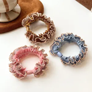 Set of 3 elastic scrunchies with golden scalloped edges in pink, brown, and blue colors