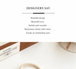 Detail of high-elasticity hair tie with champagne gold spiral texture on vintage book