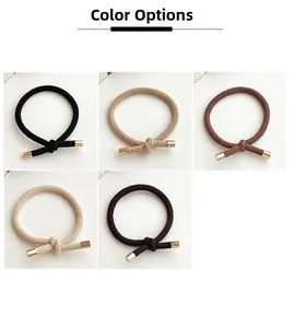 Detailed view of elastic knotted hair ties with gold metal ends in five earthy colors