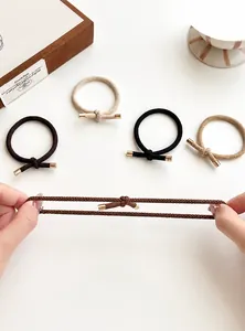 Detail showing elastic hair ties with gold metal clips and high stretch texture