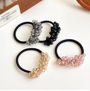 Detailed view of four high-elastic hair ties with faceted crystal beads in assorted colors