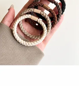Close-up of thick woven elastic hair ties in neutral earth tones with matte connectors