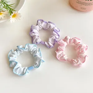 Three-piece floral scrunchie set in pastel purple, blue and pink with cute prints