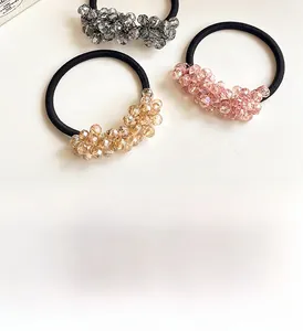 Detailed view of elastic hair ties with sparkling champagne and gray crystal beads