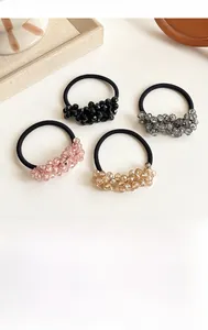 Set of four premium crystal hair ties in black, silver, pink, and champagne gold