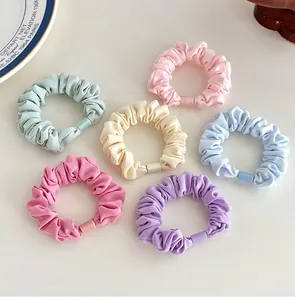 Set of 6 colorful macaron scrunchies with decorative buckles on a clean white background