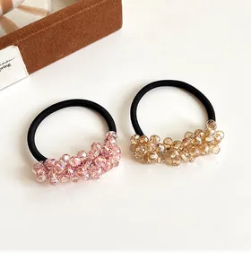 Detail of pink and champagne crystal beaded elastic hair ties with faceted cluster beads