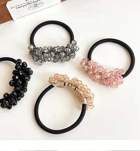 Detailed view of four elastic hair ties with multi-faceted crystal bead clusters