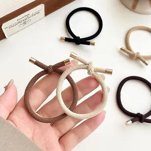 Elastic hair ties set with gold metal knots in black, beige and brown earth tones