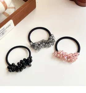 Detail of high-elasticity hair ties featuring faceted crystal beads in black, grey, and pink