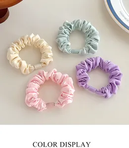 Detail view of colorful thick elastic scrunchies set in beige blue pink and purple