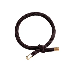 Simple high elasticity dark brown knotted hair tie with elegant gold metal cylinder caps