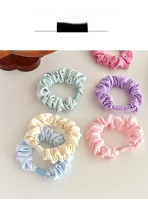 Detailed texture of thick fabric scrunchies in pastel colors with seamless resin joints