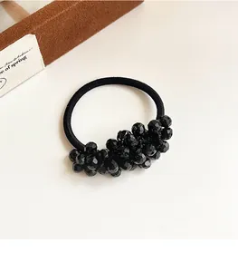 Detailed close-up of premium black faceted crystal beads on high elasticity hair tie