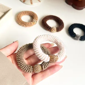 Thick knitted hair ties set with rhinestone bead accents in five neutral colors