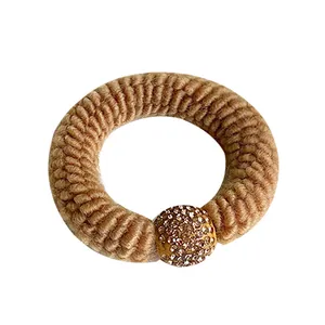 Brown knit hair tie with sparkling rhinestone sphere pendant and thick elastic spiral texture