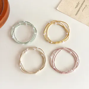 Set van 4 elastische haarelastiekjes met parels in blauw, goud, beige en roze