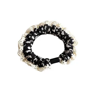 Retro cow print scrunchie with cream lace trim and high elasticity for ponytail hair