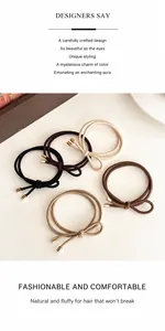 Close-up of double-strand elastic bow hair ties with gold metal tips in earthy tones