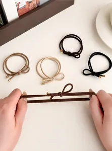 Close-up showing the high elasticity and durable dual-strand weave of the bow hair ties
