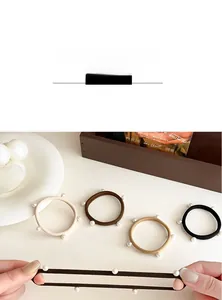 Vista dettagliata degli elastici per capelli con perle eleganti nei colori beige e marrone