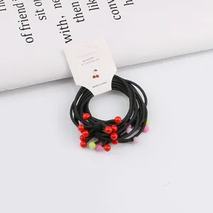 Set of 10 black elastic hair ties with colorful decorative beads on white card