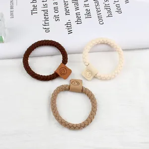 Trois élastiques à cheveux tressés en marron et beige avec charms smiley minimalistes