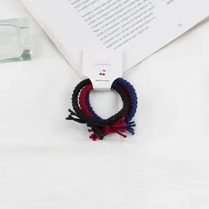 Set of 3 braided twist hair ties in black, red, and navy on a cherry display card