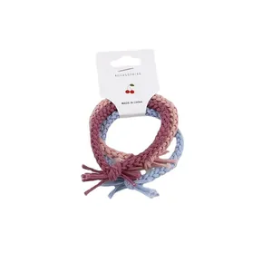 Set of 3 braided twist hair ties in pink, purple, and light blue on display card