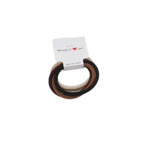 5-pack neutral earth tone ribbed elastic hair ties on a display card for ponytails