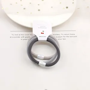 Detail of high-elasticity hair ties with iridescent oval beads on white display card