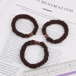 Set of 3 brown high-elasticity scrunchies with pleated fabric and a measuring ruler