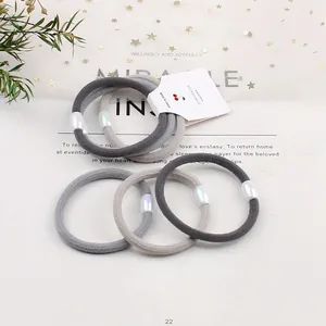 5-pack grey elastic hair ties with iridescent oval charms on minimalist display card