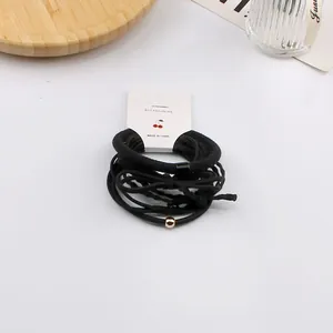 Set di 6 elastici per capelli neri ad alta elasticità con perline oro rosa su carta