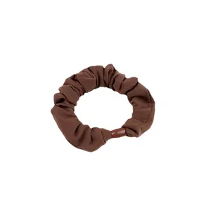 Minimalist brown fabric ice silk scrunchie with glossy resin buckle on white background