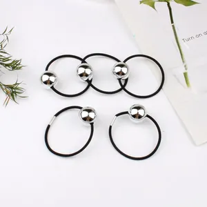 Detailed view of five high-elasticity black hair ties with polished silver metal beads