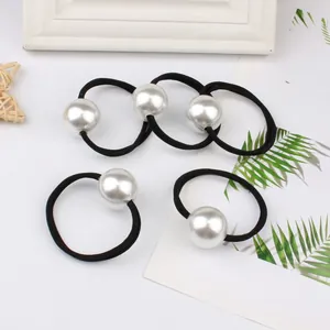 Five minimalist high-elastic hair ties featuring large white pearls on black bands