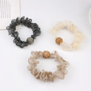 Three-pack mesh scrunchies in black, apricot and coffee with sparkling rhinestone ball
