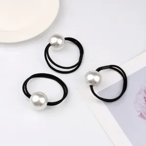 Three-piece set of minimalist pearl elastic hair ties in black for elegant ponytail styling