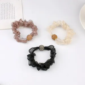 Elegant mesh hair scrunchies set with sparkling rhinestone balls in brown, beige, and black
