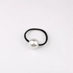 Detailed view of high-elastic black hair tie with a single large round cream pearl