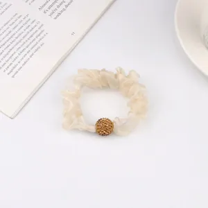 Elegant champagne mesh hair scrunchie with rhinestone bead decoration on white background
