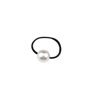 Minimalist elastic hair tie with a lustrous white pearl on black rubber band