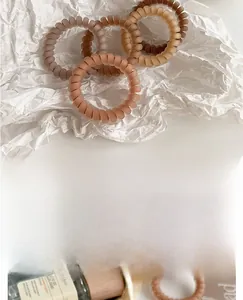 Set of matte coffee-toned spiral hair ties in various earthy shades for high ponytails