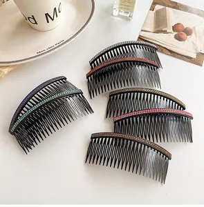 Close-up of elegant black resin hair side combs with colorful rhinestone embellishments