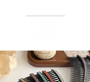 Macro detail of large hair combs with colorful rhinestones on black resin base