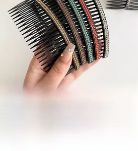 Detail of multi-color rhinestones on curved large plastic hair comb for women