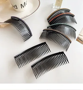 Detailed view of curved hair combs featuring colorful rhinestones on a white surface