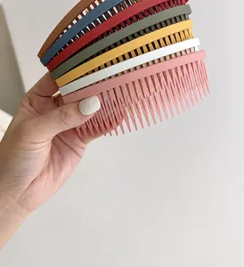 Close-up of matte textured multi-tooth hair combs in navy, olive green and beige colors